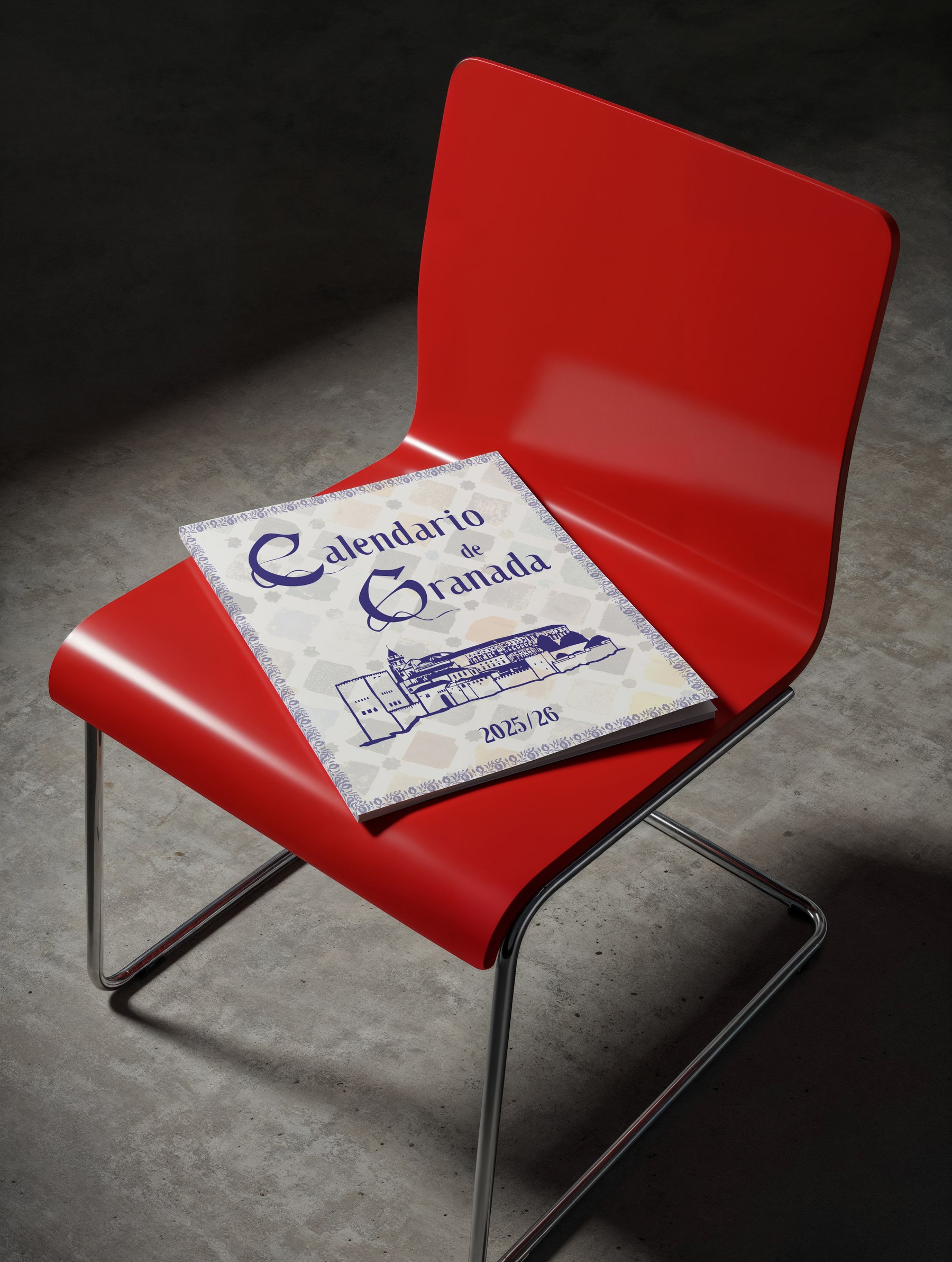 A printed calendar set in the Callejera typeface, resting on a red chair in a dark room.